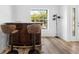 Chic bar area with stylish stools, wood floors, and natural light from the window at 10340 Ventura Dr, Spring Hill, FL 34608