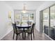 Sunlit dining area with views from the bay window, modern pendant lighting, and sliding door at 10340 Ventura Dr, Spring Hill, FL 34608