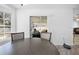 Bright dining area featuring a bay window, modern lighting, and sliding glass doors at 10340 Ventura Dr, Spring Hill, FL 34608
