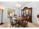 Dining room showcasing wood floors, a china cabinet, and a window at 10340 Ventura Dr, Spring Hill, FL 34608