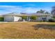 Charming home with a well-manicured front yard, enhanced by lovely landscaping and a stone accent wall at 10340 Ventura Dr, Spring Hill, FL 34608