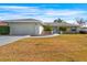 Charming home with a well-manicured front yard, enhanced by lovely landscaping and a stone accent wall at 10340 Ventura Dr, Spring Hill, FL 34608