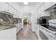 Modern kitchen features white cabinetry, granite countertops, stainless appliances, and an open layout at 10340 Ventura Dr, Spring Hill, FL 34608