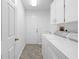 Bright laundry room with washer, dryer, sink, and storage cabinets at 10340 Ventura Dr, Spring Hill, FL 34608