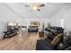 Open concept living room with neutral paint, wood-look floors, and a tv at 10340 Ventura Dr, Spring Hill, FL 34608
