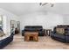 Bright living room features vaulted ceiling, wood floors, modern furniture and plenty of natural light at 10340 Ventura Dr, Spring Hill, FL 34608