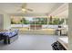 Enclosed patio features a hot tub, dining and grill area for entertaining at 10340 Ventura Dr, Spring Hill, FL 34608
