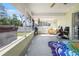 Enclosed patio offers outdoor relaxation area with a hot tub and other amenities at 10340 Ventura Dr, Spring Hill, FL 34608