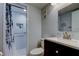 Updated bathroom featuring a shower with a glass door and a dark wood vanity at 10800 Us Highway 19 N # 108, Pinellas Park, FL 33782