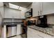 Well-lit kitchen with stainless steel appliances and white cabinetry at 10800 Us Highway 19 N # 108, Pinellas Park, FL 33782