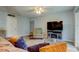 Cozy living room featuring wood-look tile floors, ceiling fan and a flat screen tv at 10800 Us Highway 19 N # 108, Pinellas Park, FL 33782