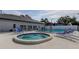 Community pool and hot tub with lounge chairs at 10800 Us Highway 19 N # 108, Pinellas Park, FL 33782