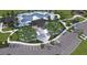 Aerial view of a community pool, parking, playground, and green space at 10869 Gentle Current Way, Parrish, FL 34219