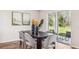 Elegant dining room with modern chairs, black table, and sliding glass doors, perfect for hosting gatherings at 10869 Gentle Current Way, Parrish, FL 34219