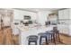 Stylish kitchen island with white cabinets, counter seating, stainless appliances, and lovely quartz countertops at 10869 Gentle Current Way, Parrish, FL 34219