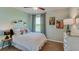 Cozy bedroom featuring stylish decor, neutral color palette, and natural light from a window at 10866 Gentle Current Way, Parrish, FL 34219