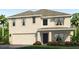 Two-story home with a two-car garage, neutral stucco, shutters, and minimal landscaping at 10866 Gentle Current Way, Parrish, FL 34219