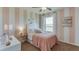 Bright bedroom featuring pink and white striped walls, soft textures, and natural light at 10870 Gentle Current Way, Parrish, FL 34219