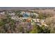 Aerial view of a home nestled in a peaceful neighborhood with a pond, showcasing its location and surrounding landscape at 11446 Sinatra, New Port Richey, FL 34654