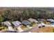 An aerial shot of a home surrounded by green spaces and neighboring houses in a neighborhood at 11446 Sinatra, New Port Richey, FL 34654