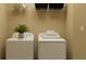 Bright laundry room with washer, dryer, and shelving at 11559 E 71St Ter, Palmetto, FL 34221