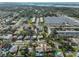 An aerial view captures a neighborhood with homes featuring inviting pools and verdant, mature landscaping at 12341 79Th Pl, Seminole, FL 33772