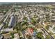 An aerial view of a residential neighborhood featuring a home with a private pool and lush landscaping at 12341 79Th Pl, Seminole, FL 33772