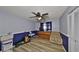 Unique bedroom featuring musical instruments and chair under ceiling fan at 12341 79Th Pl, Seminole, FL 33772