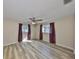 Spacious bedroom with wood-look vinyl flooring, ceiling fan, and natural light at 12341 79Th Pl, Seminole, FL 33772