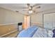 This bedroom features neutral colors, wood flooring, and a double closet for storage at 12341 79Th Pl, Seminole, FL 33772