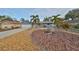 Charming single-story home featuring a well-manicured front yard with palm trees, rock and mature landscaping at 12341 79Th Pl, Seminole, FL 33772