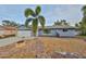 Landscaped front yard with stone accents and a covered entrance, offering curb appeal at 12341 79Th Pl, Seminole, FL 33772
