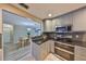 Kitchen with stainless appliances and granite countertops with an open view to dining area at 12341 79Th Pl, Seminole, FL 33772