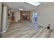 Spacious living room with updated floors, brick fireplace, and view into other rooms at 12341 79Th Pl, Seminole, FL 33772