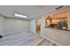 Bright living room offering skylight, open view, and a view to the kitchen and dining area at 12341 79Th Pl, Seminole, FL 33772