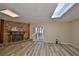 Cozy living room with a brick fireplace, skylights, and modern floors at 12341 79Th Pl, Seminole, FL 33772