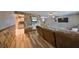 Open-concept living room featuring hardwood floors, a stone accent wall, and lots of natural light at 12341 79Th Pl, Seminole, FL 33772