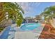 This beautiful pool is surrounded by palm trees, offering a refreshing oasis for relaxation and recreation at 12341 79Th Pl, Seminole, FL 33772