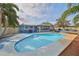 Inviting backyard pool area with a covered patio and outdoor cooking space perfect for entertaining at 12341 79Th Pl, Seminole, FL 33772