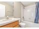 Standard bathroom featuring a shower-tub combo with white tiling and a single sink vanity at 12704 Country Brook Ln, Tampa, FL 33625