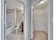Bright bathroom featuring a shower-tub combo, tile floors, and wood vanity at 12973 Dream Catcher Way, Riverview, FL 33579