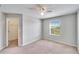 Bedroom featuring a ceiling fan, a walk-in closet, neutral walls and large window at 12973 Dream Catcher Way, Riverview, FL 33579