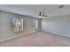 Spacious bedroom with carpet, two windows, and a ceiling fan at 12973 Dream Catcher Way, Riverview, FL 33579