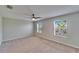 Bright bedroom with a ceiling fan and windows offering natural light and neighborhood views at 12973 Dream Catcher Way, Riverview, FL 33579