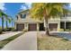 The exterior view displays a two-story house featuring attached garages and well-manicured landscaping at 12973 Dream Catcher Way, Riverview, FL 33579