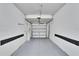 Spacious two car garage with white walls and new epoxy floor at 12973 Dream Catcher Way, Riverview, FL 33579