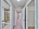 Hallway view of bathroom featuring neutral walls, shower, toilet, and tile floors at 12973 Dream Catcher Way, Riverview, FL 33579