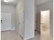 A bright hallway with tile flooring leads to a half bathroom and the home's entrance at 12973 Dream Catcher Way, Riverview, FL 33579