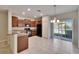 Modern kitchen with dark cabinetry, black appliances, granite counters, and an adjoining dining area at 12973 Dream Catcher Way, Riverview, FL 33579