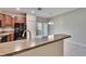 Contemporary kitchen featuring a peninsula bar and stainless steel appliances adjacent to a dining area with sliding doors at 12973 Dream Catcher Way, Riverview, FL 33579